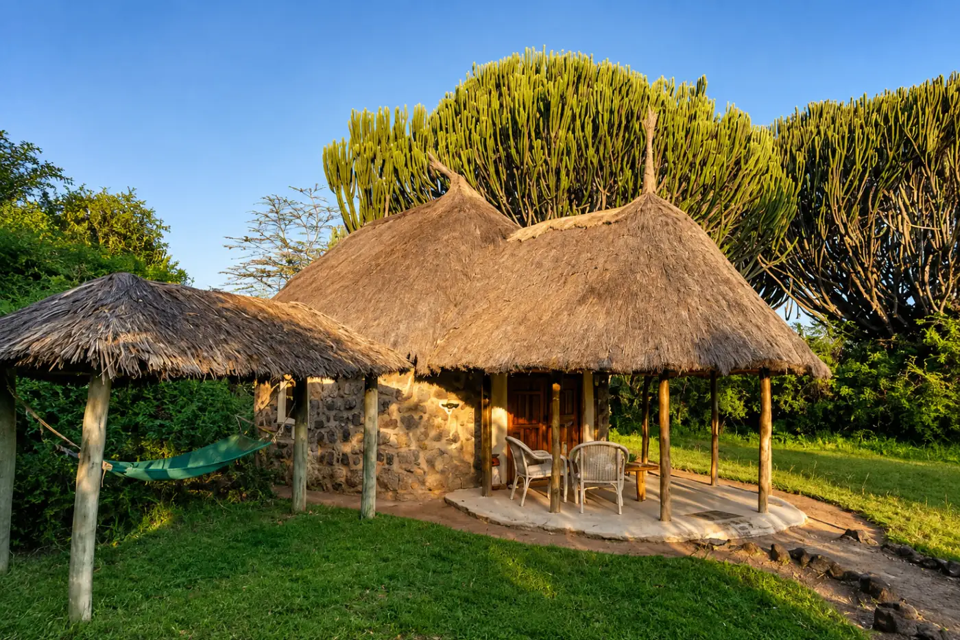 Thatched stone cottage with private veranda at Mbweha Camp