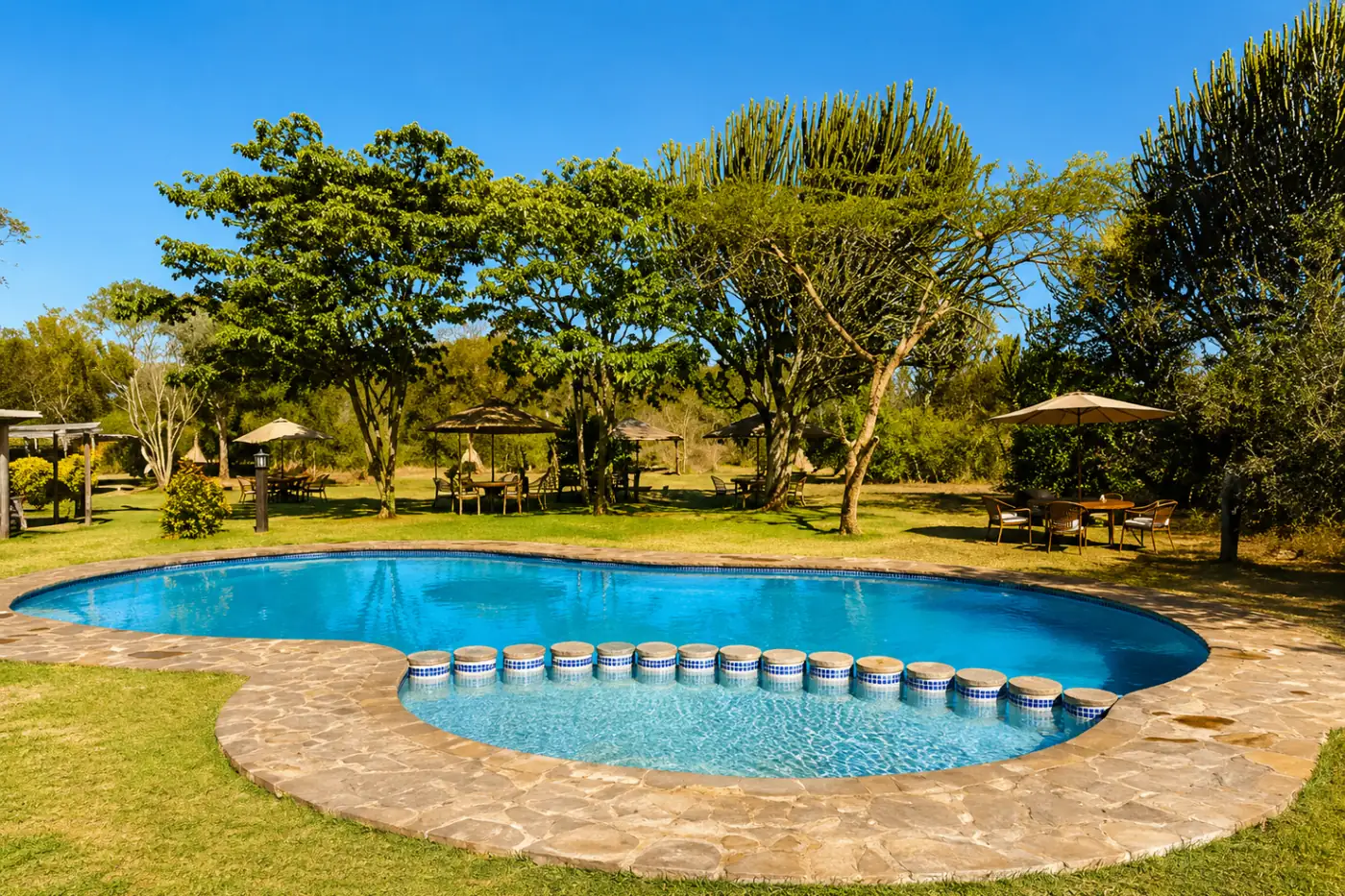 Swimming pool and lawns at Mbweha Camp