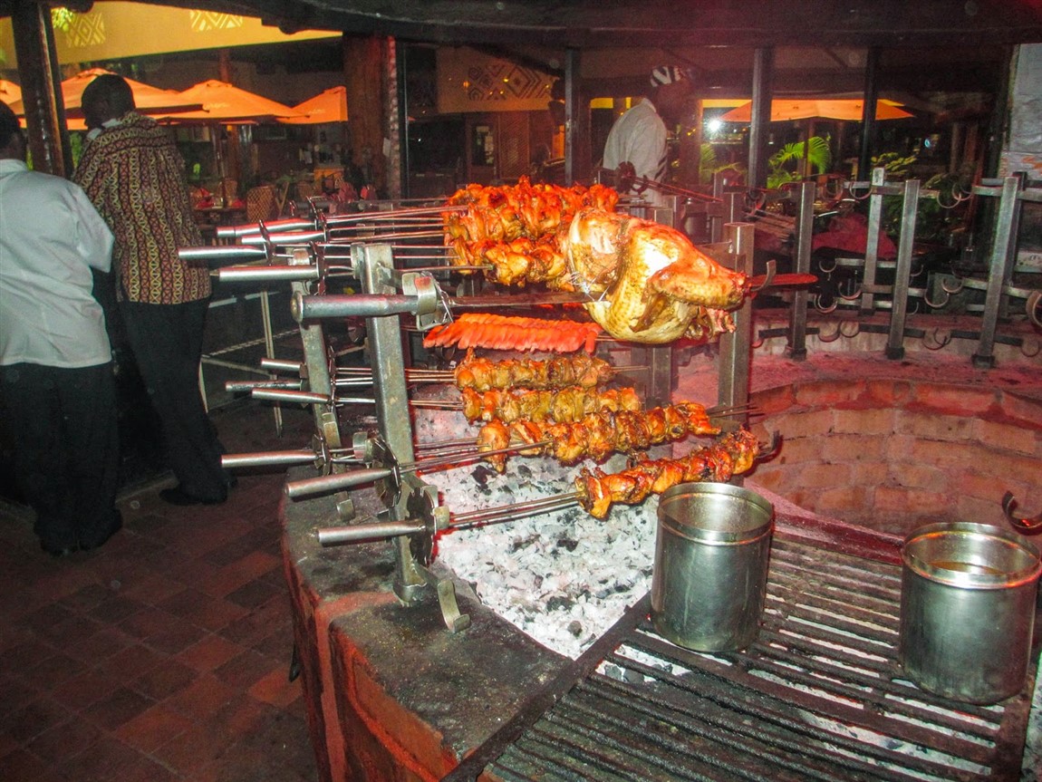 Skewers of game and chicken roasting over the fire
