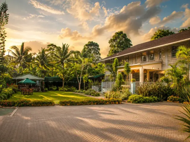 Acacia Tree Lodge exterior and gardens at sunset