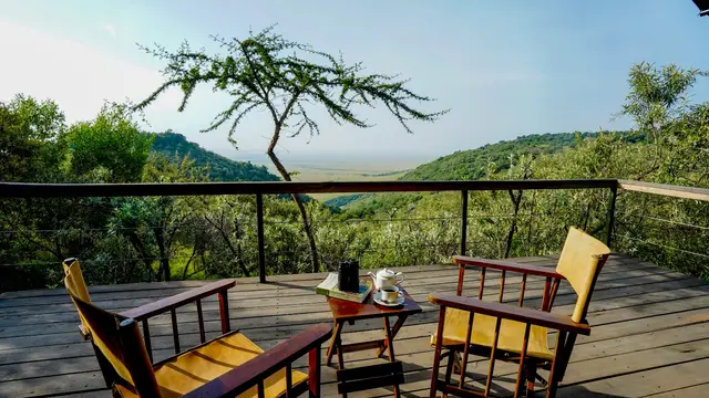 Coffee and binoculars on a private camp deck looking out over the savannah