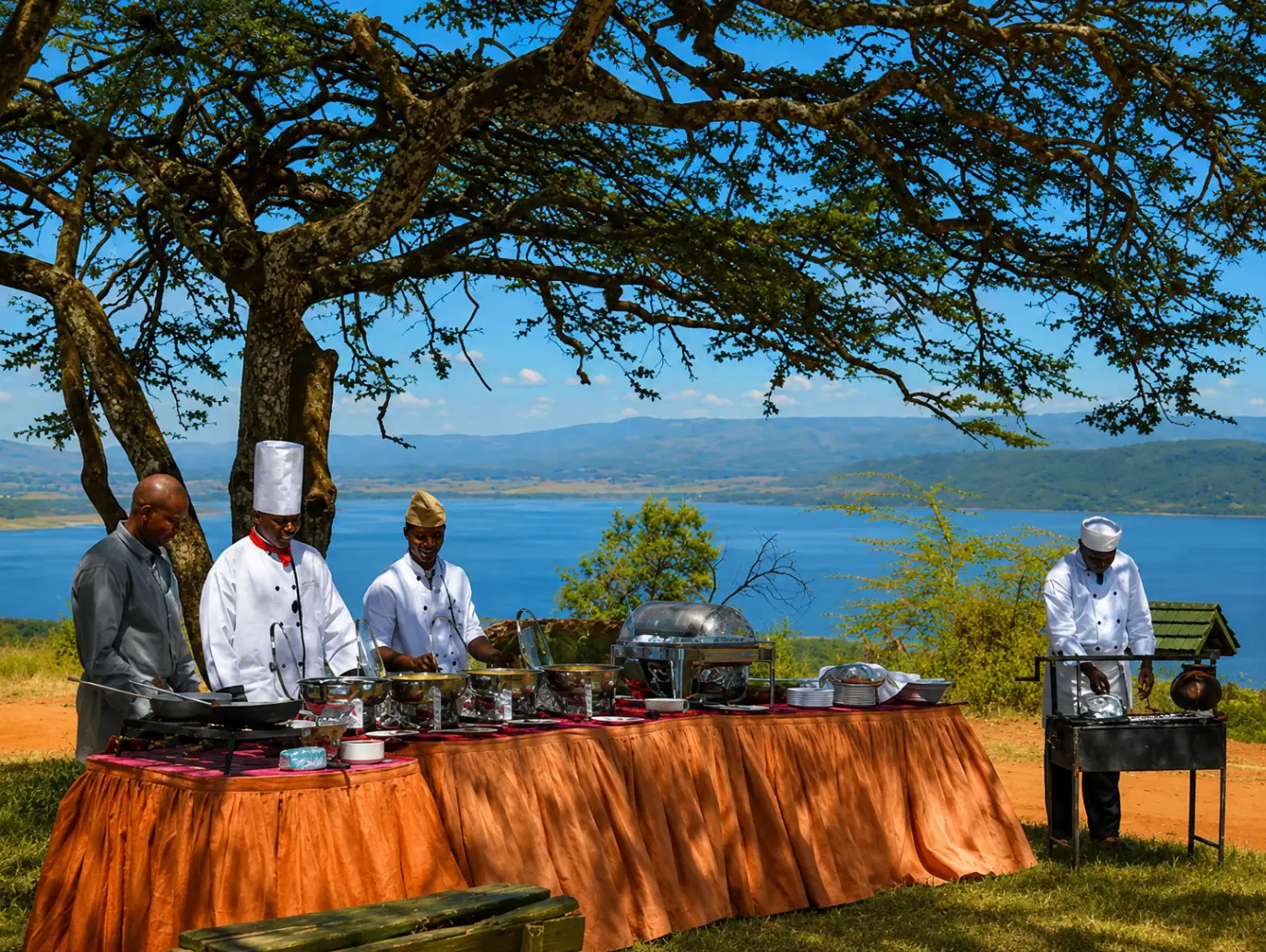 Chefs preparing an outdoor buffet beside the lake