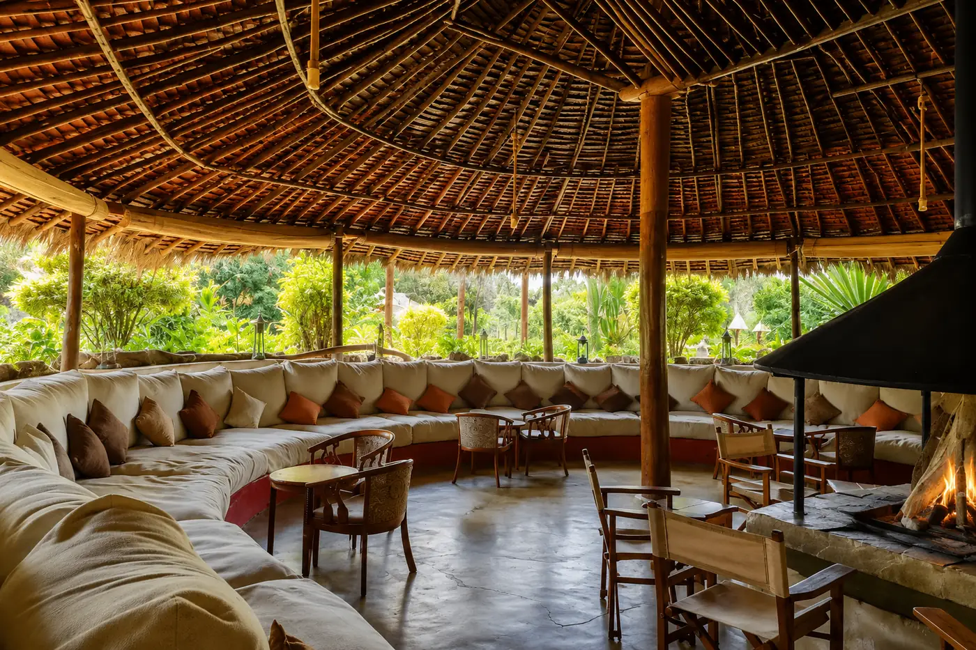 Circular thatched lounge with central fireplace at Mbweha Camp